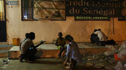 Dominika, Issa Kouyate and members of his team checking on boys sleeping in the street. Kouyate says most of them tell him they've run away from their daaras