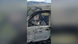 The burnt wreckage of a vehicle transporting a Mormon family living near the border with the U.S. is seen, after the family was caught in a crossfire between unknown gunmen from rival cartels, in Bavispe, Sonora, Mexico November 4, 2019, in this screengrab from a video obtained from social media. 