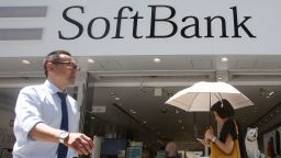 People walk by a SoftBank shop in Tokyo, Wednesday, Aug. 7, 2019.