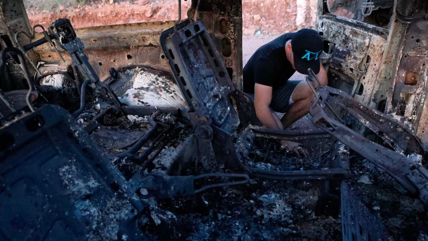 A member of the Lebaron family looks at the burned car where part of the nine murdered members of the family were killed and burned during an ambush in Bavispe, Sonora mountains, Mexico, on November 5, 2019. - US President Donald Trump offered on November 5 to help Mexico "wage war" on its cartels after three women and six children from an American Mormon community were murdered in an area notorious for drug traffickers. (Photo by HERIKA MARTINEZ / AFP) (Photo by HERIKA MARTINEZ/AFP via Getty Images)
