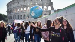 A student bounces an inflatable earth beach ball during a protest against global warming by the Colosseum (Colosseo, Colisee) in central Rome on March 15, 2019. (Photo by Andreas SOLARO / AFP)        (Photo credit should read ANDREAS SOLARO/AFP via Getty Images)