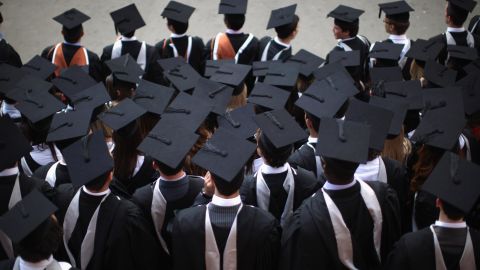 Students pose for graduation photos. A new report from UK lawmakers has warned about Chinese influence on British campuses. 