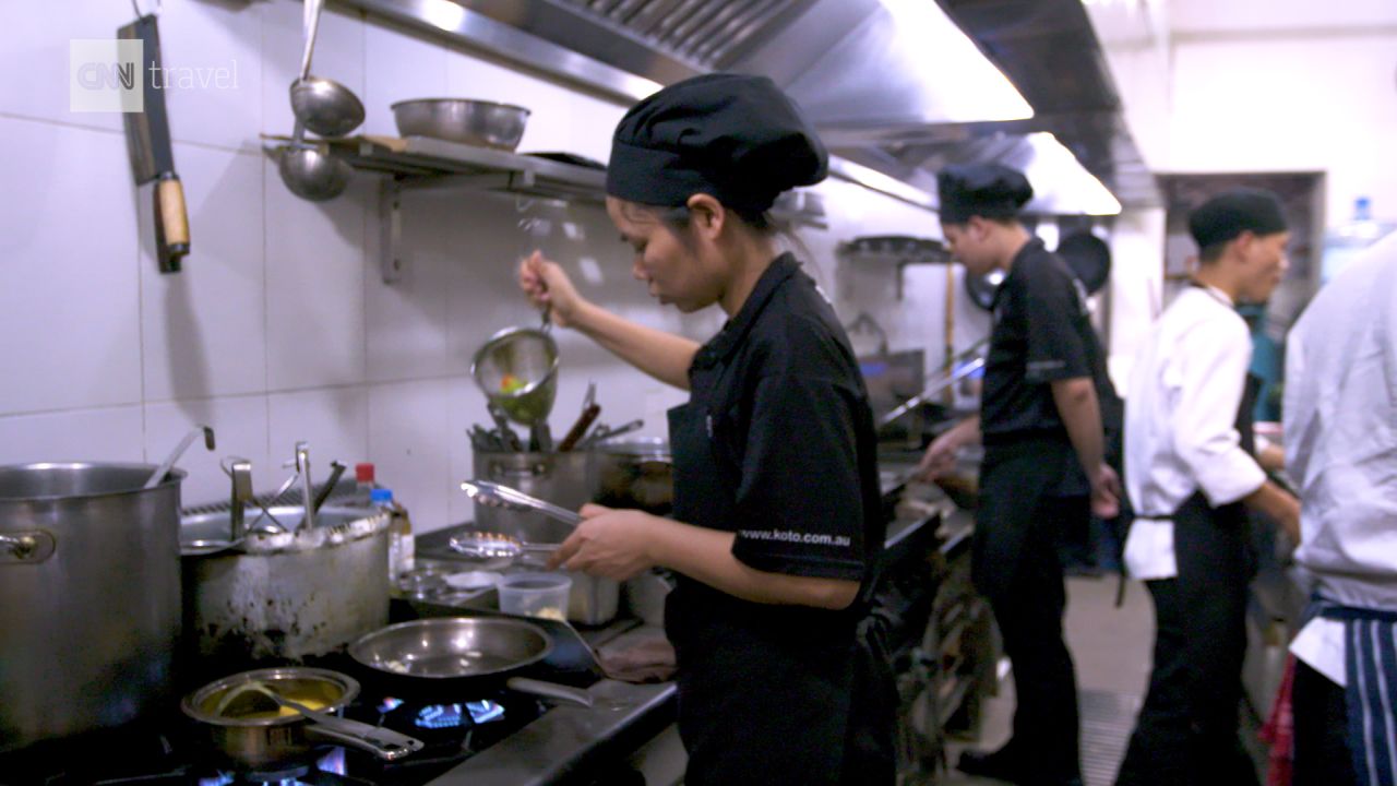 Employees work the line in the Hanoi KOTO kitchen.