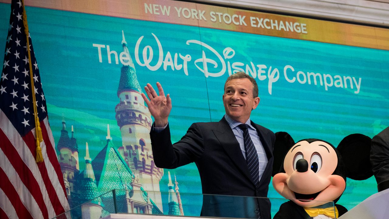 Bob Iger and Mickey Mouse look on before ringing the opening bell at the New York Stock Exchange in November 2017, marking the company's 60th anniversary as a publicly-traded company. (Drew Angerer/Getty Images)