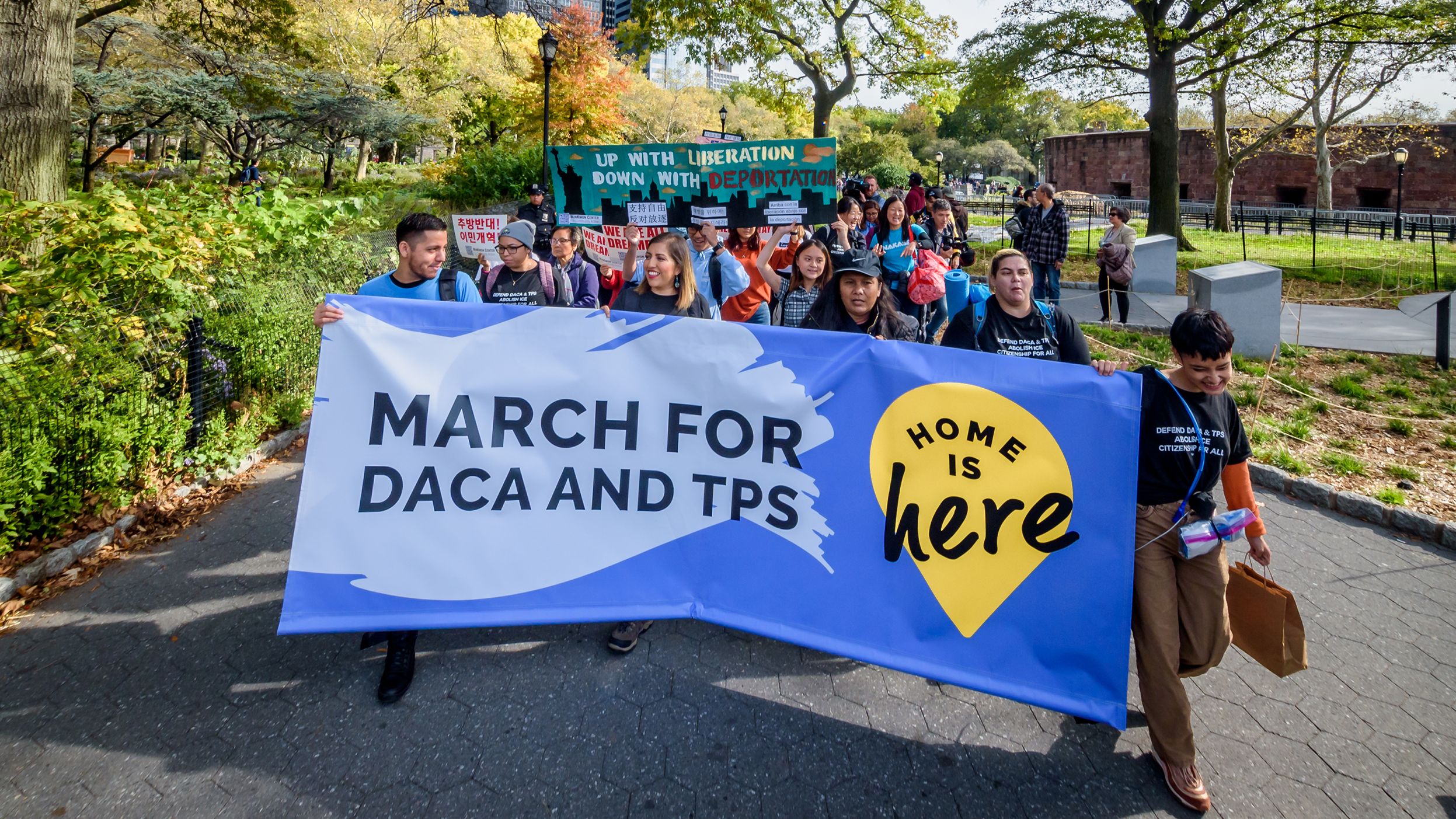 Eliana Fernández (holding banner, second from left) and other demonstrators are on a 230-mile march from New York to Washington. Their journey will end Tuesday at the Supreme Court. 