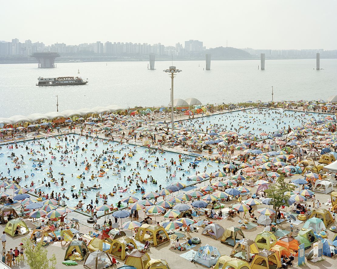 Kim photographed a packed swimming pool by the city's Han river in 2016. 