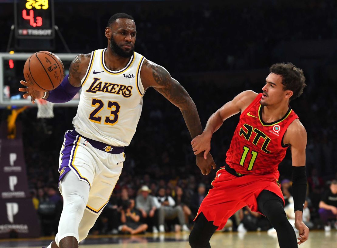 Trae Young #11 of the Atlanta Hawks guards LeBron James #23 of the Los Angeles Lakers during the game at Staples Center on November 11, 2018 in Los Angeles, California.