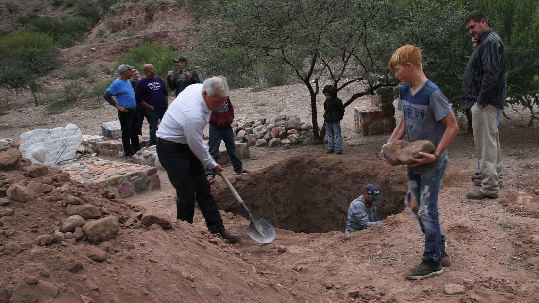 Men dig a mass grave in La Mora on Thursday for some of the women and children who were killed in Monday's massacre.