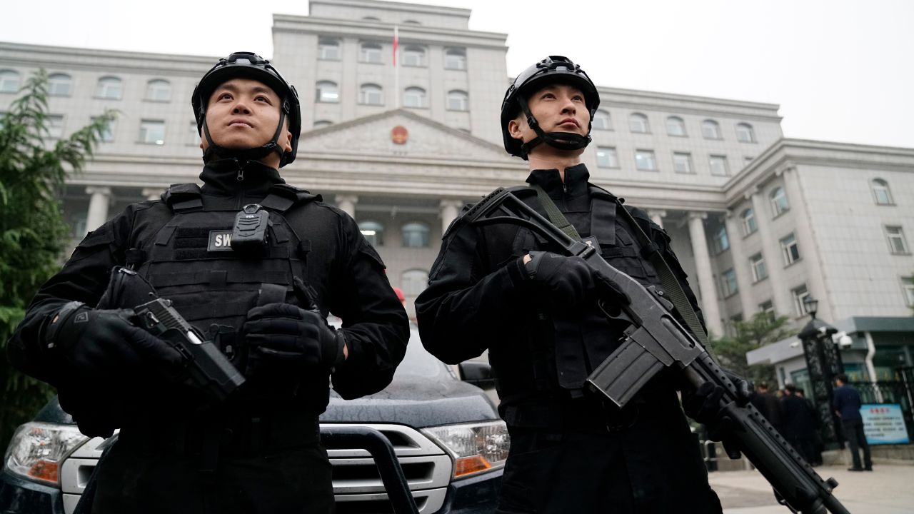 Two guards stand outside the Xingtai Intermediate People's Court in Hebei Province on Thursday November 7.