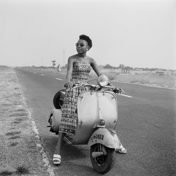 A woman poses with a Vespa in 1961, the year after Senegal's independence. 