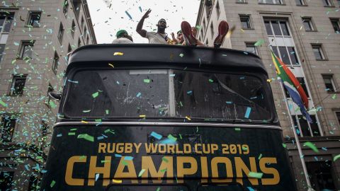 South African Rugby captain Siya Kolisi (C) celebrates as the World Cup winning team parades through the streets of Johannesburg.