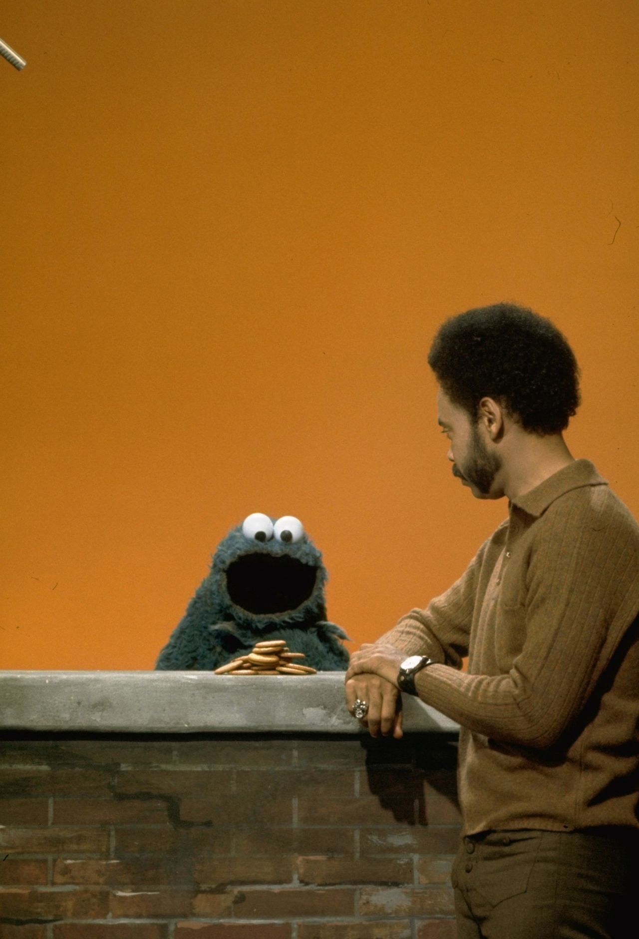 Actor Matt Robinson, the first actor to play Gordon on the show, chats with Cookie Monster.