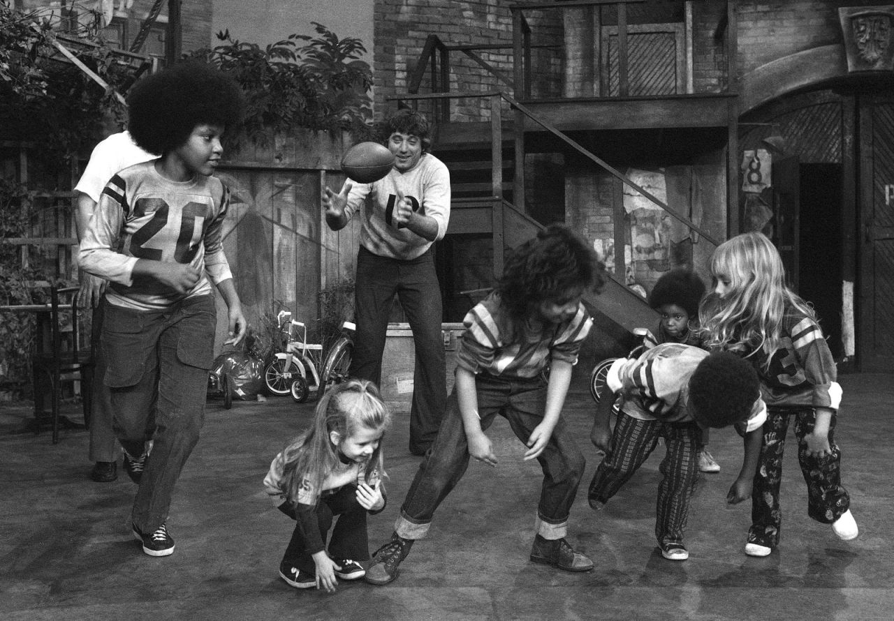 Football quarterback Joe Namath plays with children on the "Sesame Street" set in 1972.