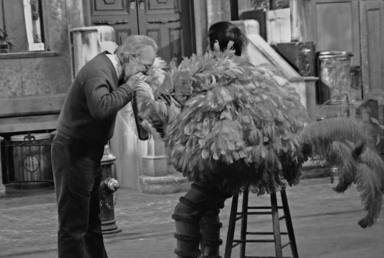 Someone makes an adjustment to Spinney's Big Bird costume while he is in it in 1970. In full costume, Big Bird is more than 8 feet tall.