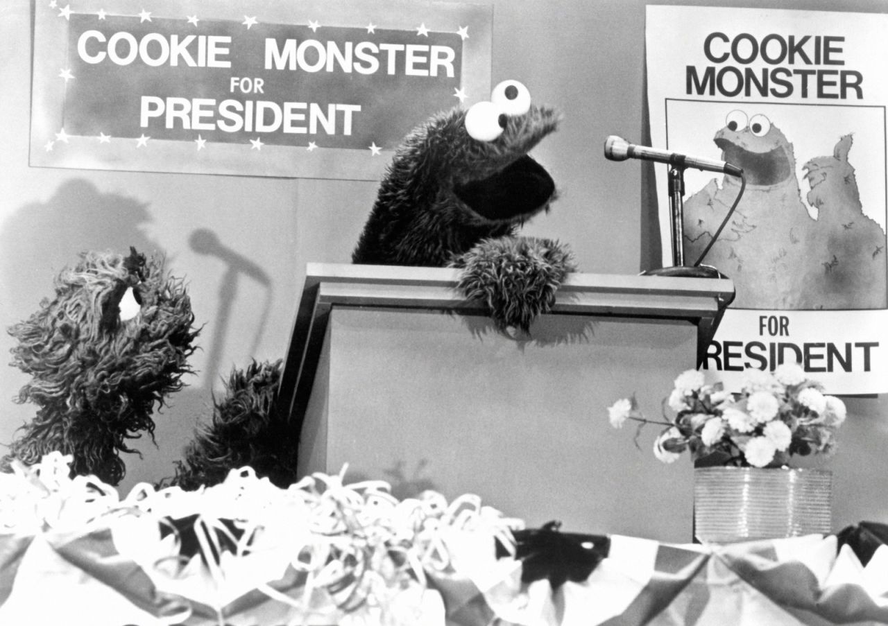 Cookie Monster runs for president in 1976. He promised that if people voted for him, there would be a cookie in every pot. Oscar was his campaign manager.