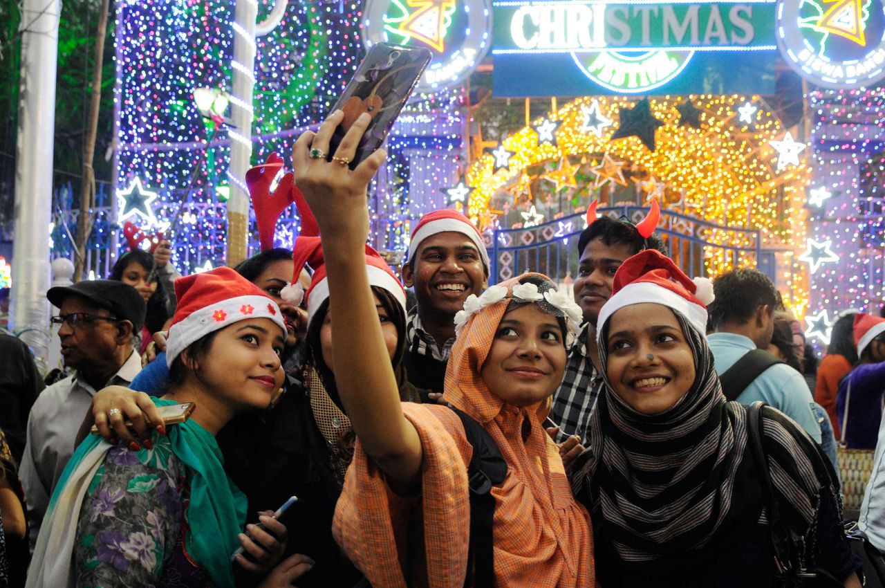 A group of young people takes a selfie during Christmas Eve celebrations  on Park Street in Kolkata.