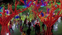 People attend the Christmas lights illumination in the Medellin river on December 1, 2012 in Medellin, Antioquia department, Colombia.