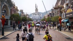 Visitors walk through Main Street USA in front of the under construction Sleeping Beauty Castle, center, at Walt Disney Co.'s Disneyland Resort in Hong Kong, China, on Sept. 27, 2019. 