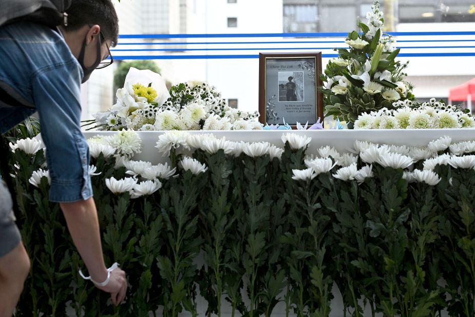 A person places a flower at a memorial for 22-year-old Hong Kong university student Chow Tsz-lok on November 8.