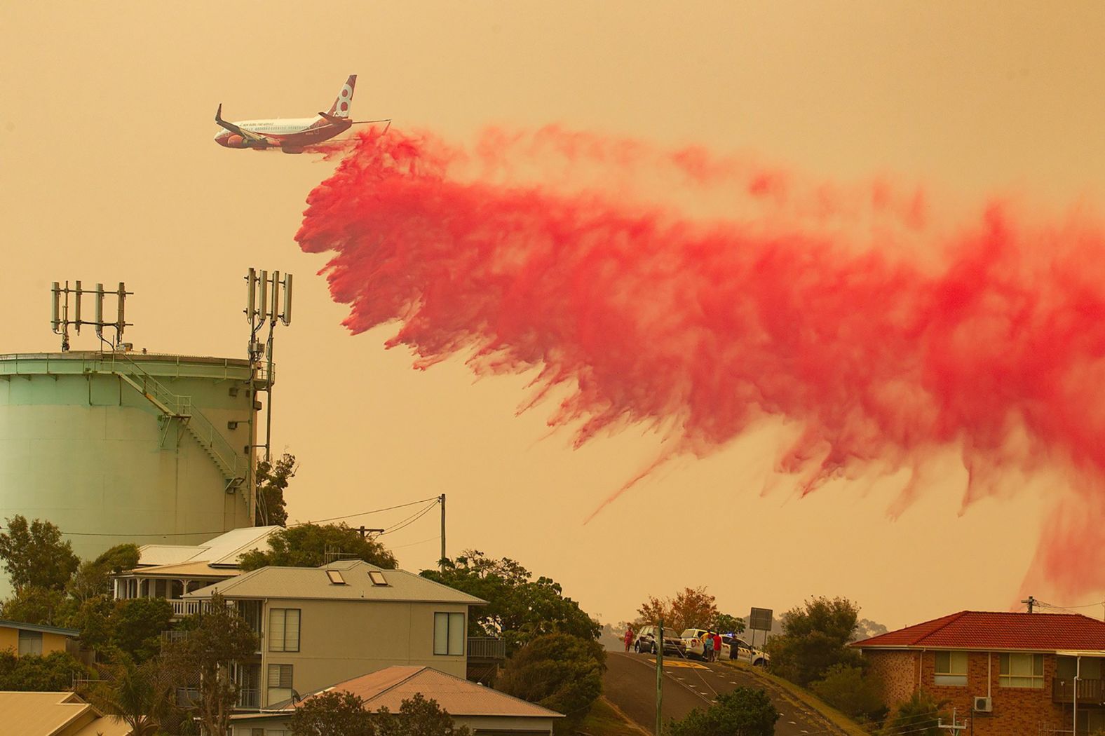 A plane drops fire retardant on a bushfire in Harrington on November 8.