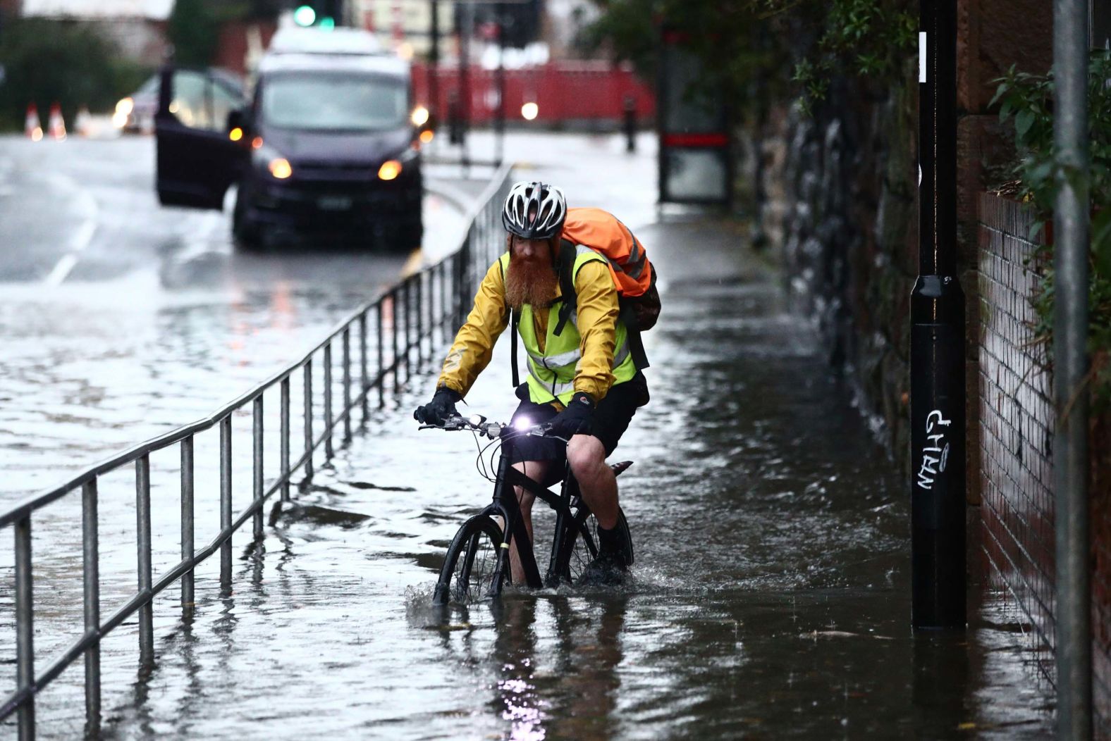 A man cycles through a flooded street in Sheffield, England, on Thursday, November 7.