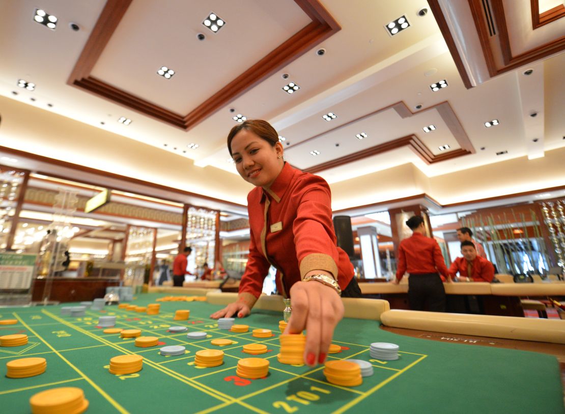 An employee of Solaire Manila Resorts and casino checks chips. In their free time, POGO employees often gamble and end up in debt, falling prey to loan sharks.