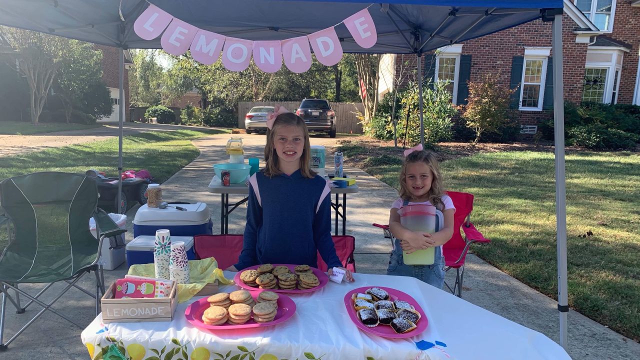 Alex, left, and Caroline made $969 in cash from their lemonade stand this year. They raised almost $2,000 additional funds through donations.