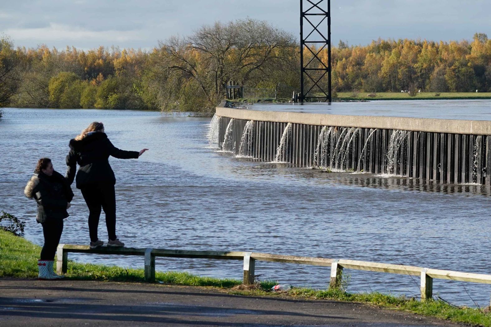 People look on as the River Don threatens to burst its banks on November 8 in Kirk Sandall.