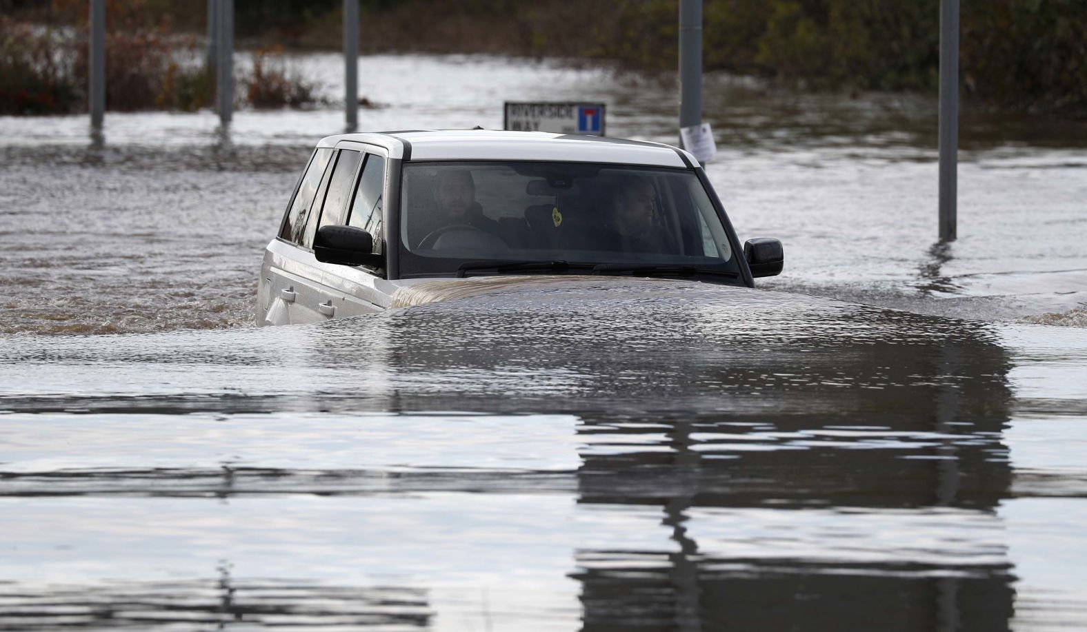 A vehicle is driven through flood waters after the River Don burst its banks on Friday, November 8 in Rotherham, United Kingdom.