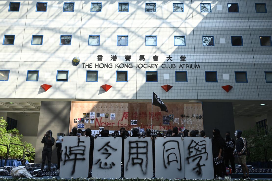 Students of Hong Kong University of Science and Technology (HKUST) hold signs mourning Chow Tsz-lok in Hong Kong on November 8, 2019.