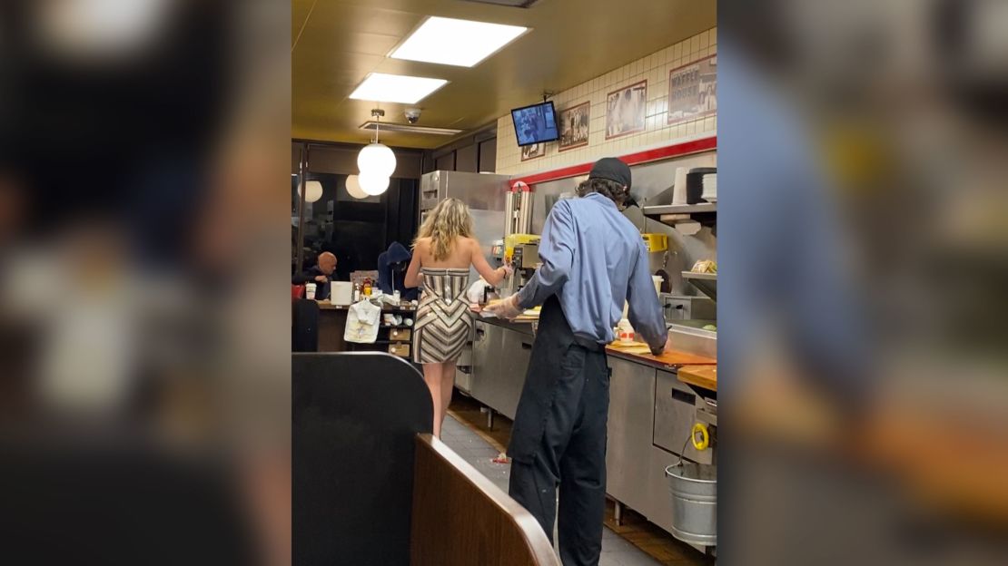 After a night out, a woman in heels saw to clearing tables and stacking cups.