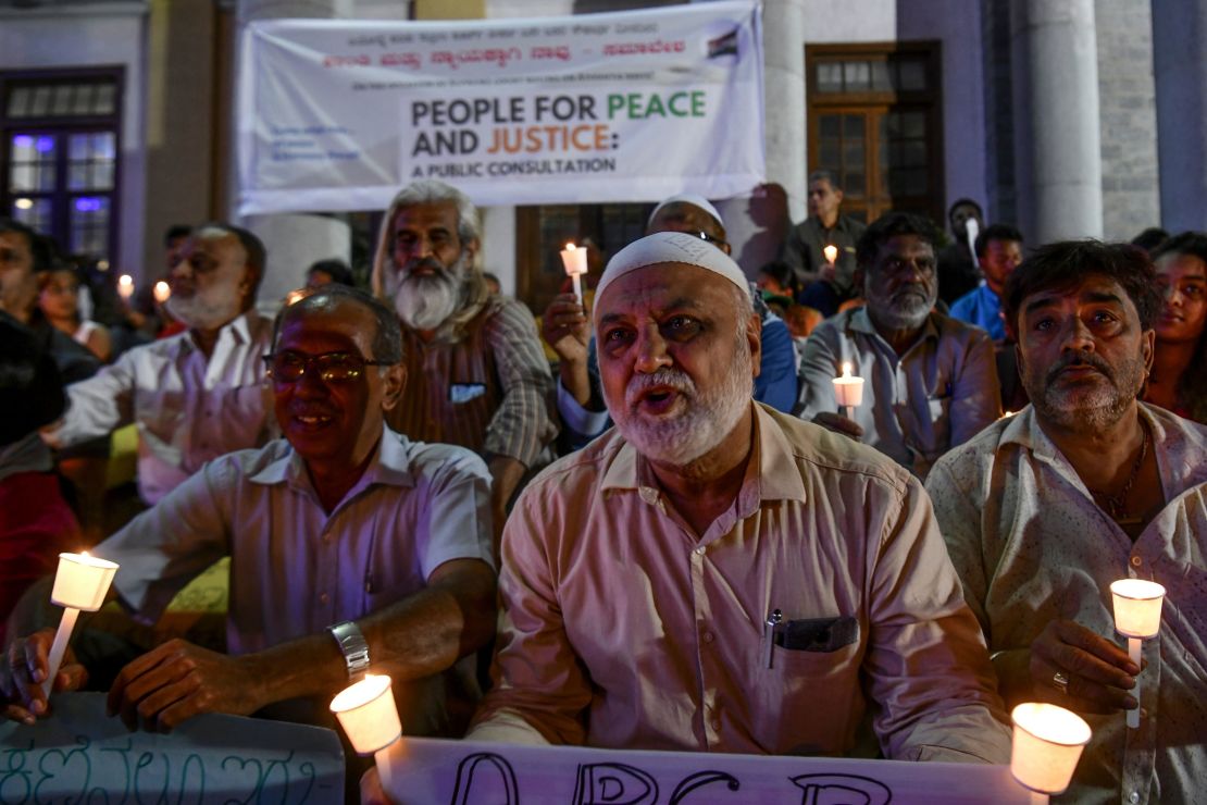 Activists stage a candle light vigil urging people belonging to all religious communities to maintain peace and harmony before the Supreme Court verdict on Ayodhya, in Bangalore on November 7, 2019.