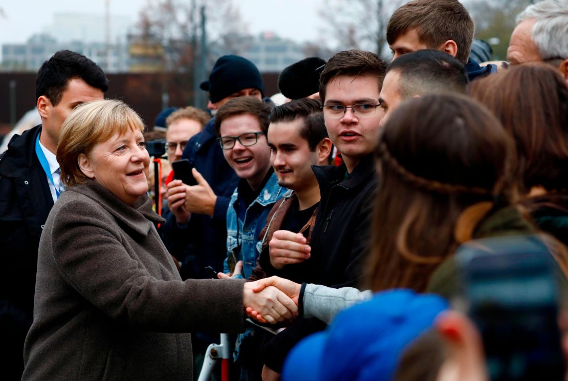 Merkel greets visitors as she walks to the Chapel of Reconciliation before attending a memorial service to commemorate the 30th anniversary of the fall of the Berlin Wall, on November 9, 2019.