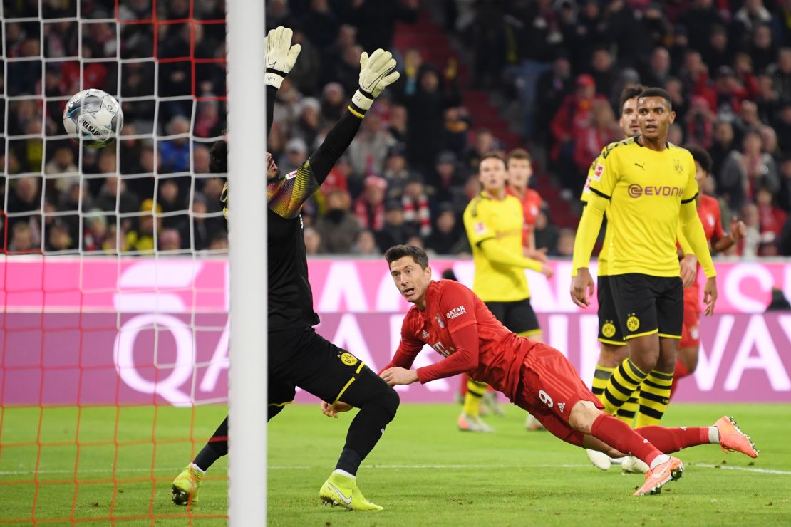 Robert Lewandowski heads Bayern Munich ahead against Borussia Dortmund as he maintained his record of scoring in every Bundesliga match since the start of the season. 