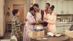 From left, American actors Ralph Carter, Esther Rolle (1920 - 1998), John Amos, Jimmie Walker, and BernNadette Stanis gather in the kitchen in a scene from the television show 'Good Times,' Los Angeles, California, 1975. (Photo by CBS Photo Archive/Getty Images)