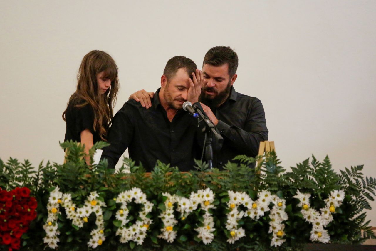 Tyler Johnson, the widower of Christina Marie Langford, mourns during her funeral service.