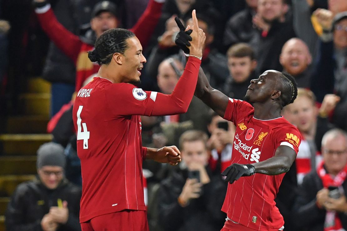 Liverpool's Senegalese striker Sadio Mane celebrates with Virgil van Dijk (left) after scoring his side's third goal early in the second half at Anfield.  