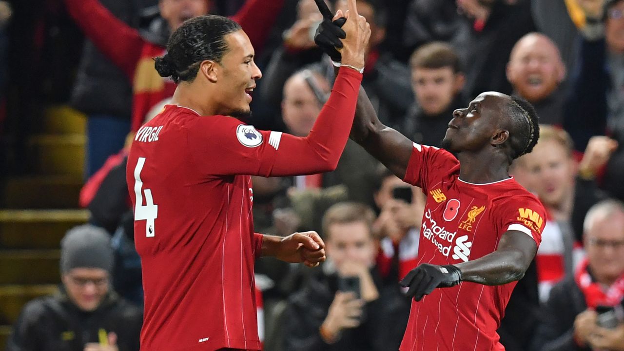 Liverpool's Senegalese striker Sadio Mane celebrates with Virgil van Dijk (left) after scoring his side's third goal early in the second half at Anfield.