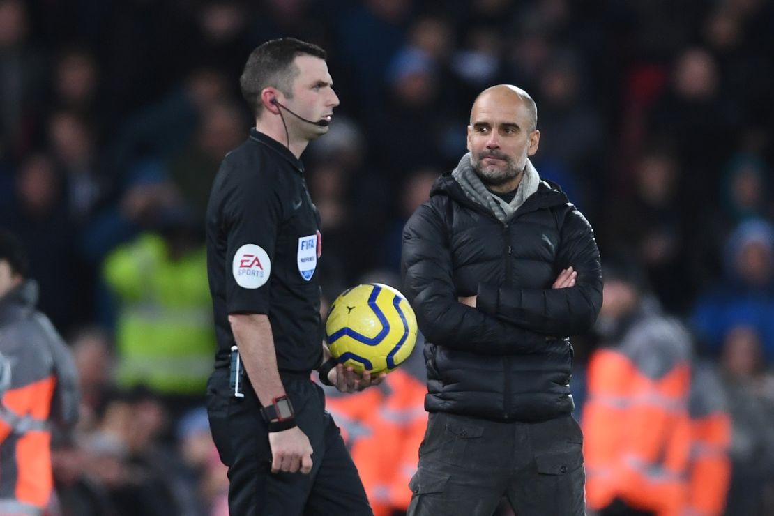 Manchester City manager Pep Guardiola stares pointedly at referee Michael Oliver as he walks out to officiate the second half of the title showdown at Anfield.  