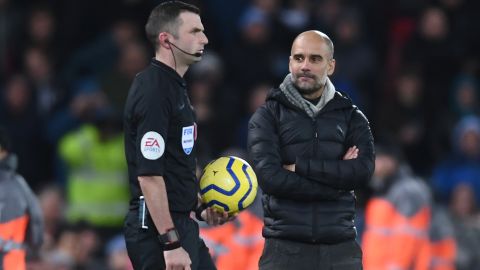 Manchester City manager Pep Guardiola stares pointedly at referee Michael Oliver as he walks out to officiate the second half of the title showdown at Anfield.  