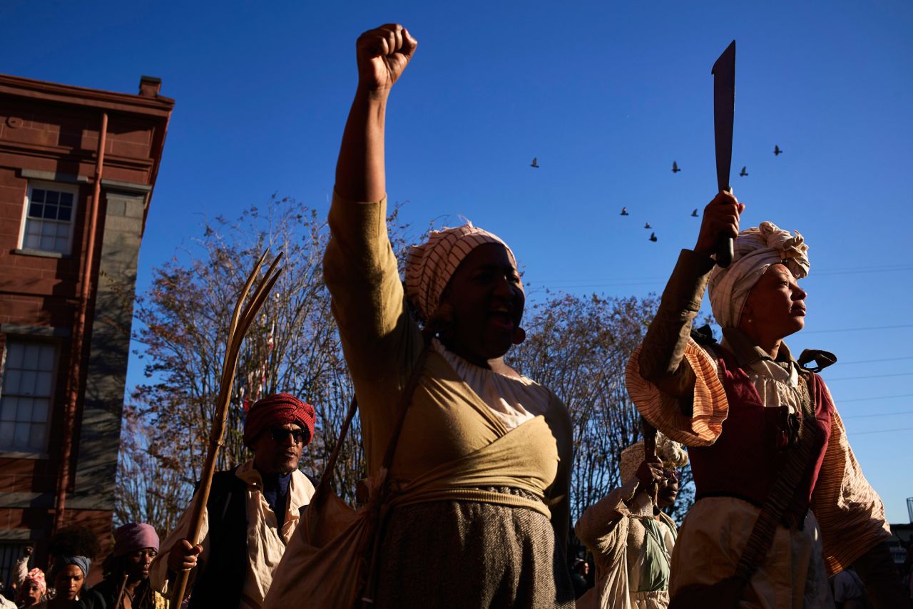 Chanting "freedom or death," reenactors march through the French Quarter of New Orleans on Saturday.