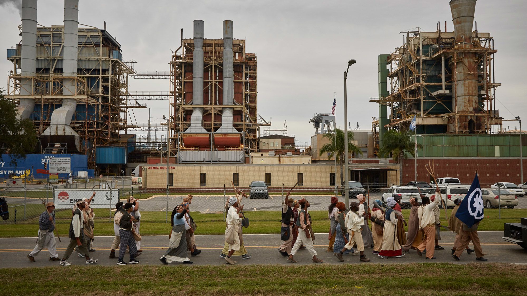 Reenactors march past Entergy's Little Gypsy power plant in Montz, Louisiana. The route they followed was once home to many plantations along the Mississippi River. These have been replaced by many industrial facilities, leading to the nickname "Cancer Alley."