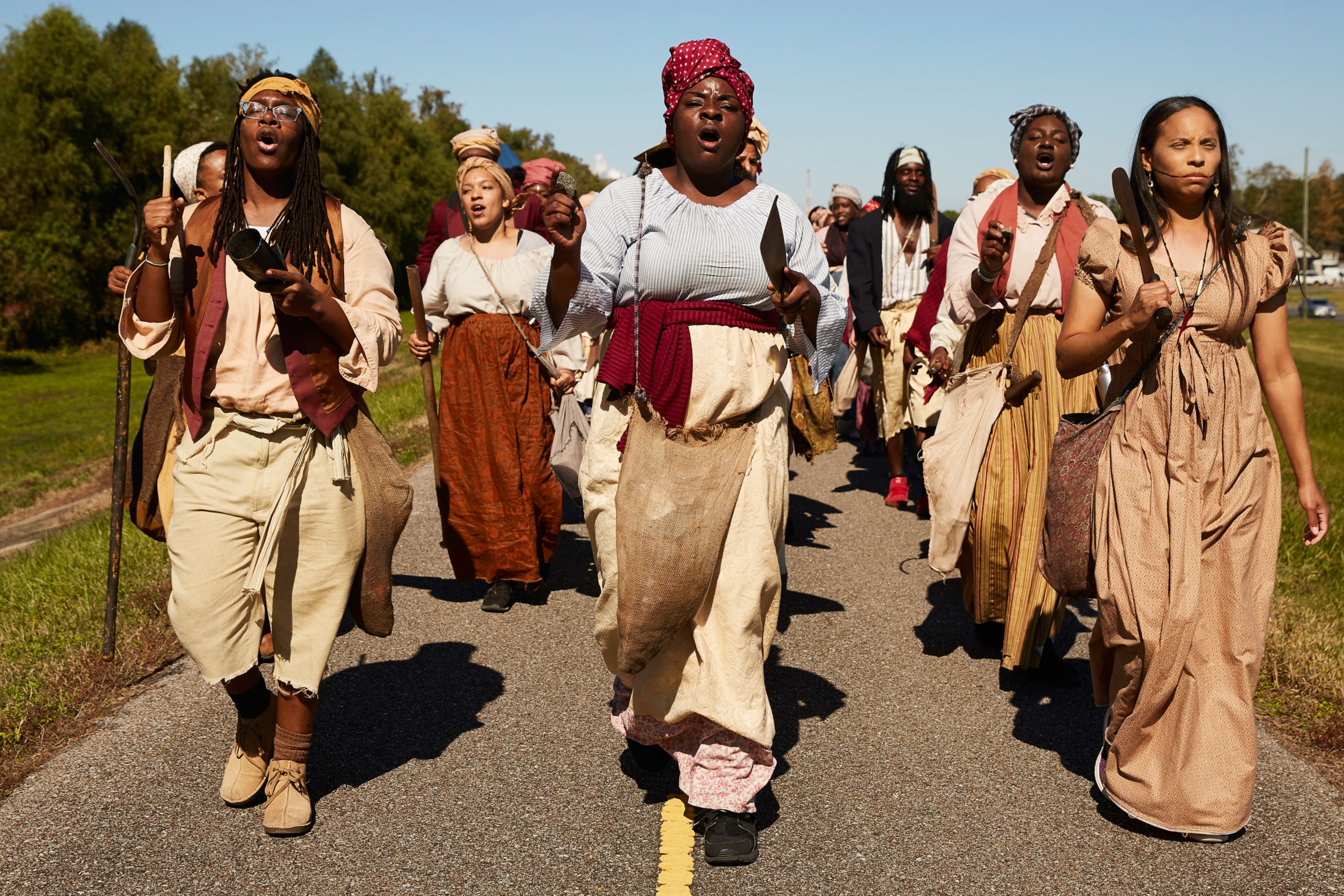 Marching atop the Mississippi River levee in New Sarpy, Louisiana, on Saturday, March 9, reenactors chant, "On to New Orleans, freedom or death -- we're going to end slavery."