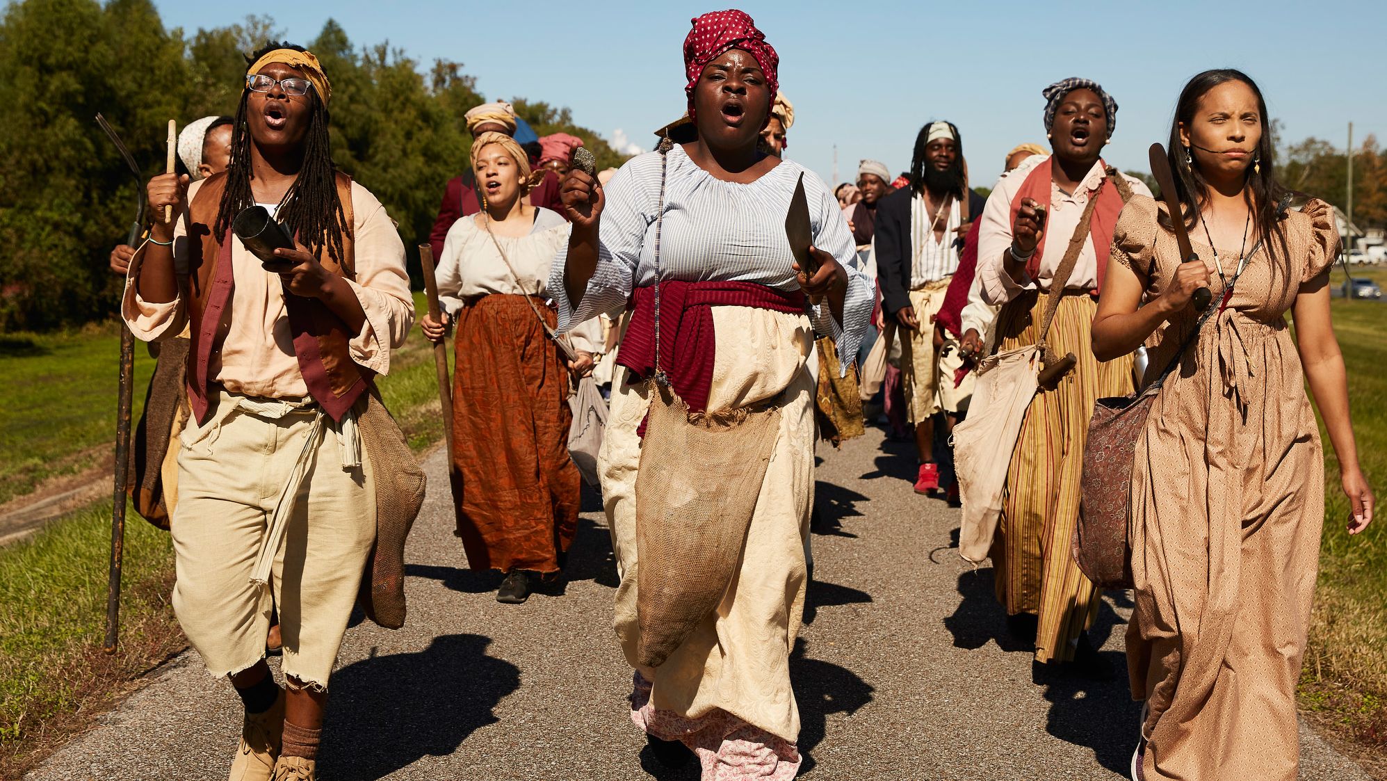 Marching atop the Mississippi River levee in New Sarpy, Louisiana, on Saturday, March 9, reenactors chant, "On to New Orleans, freedom or death -- we're going to end slavery."