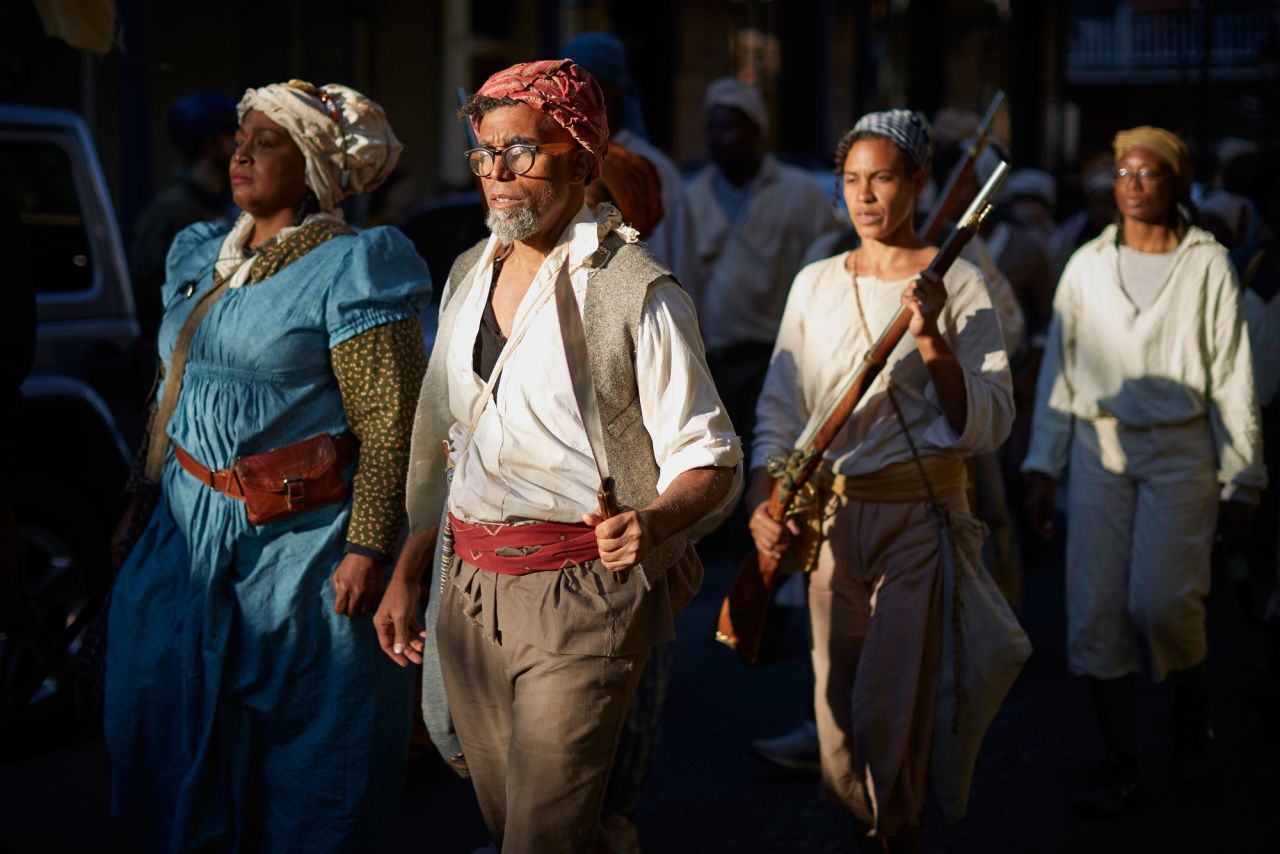 Artist Dread Scott, second from left, marches through New Orleans. Scott spent six years planning the march in conjunction with other artists, historians and community members.