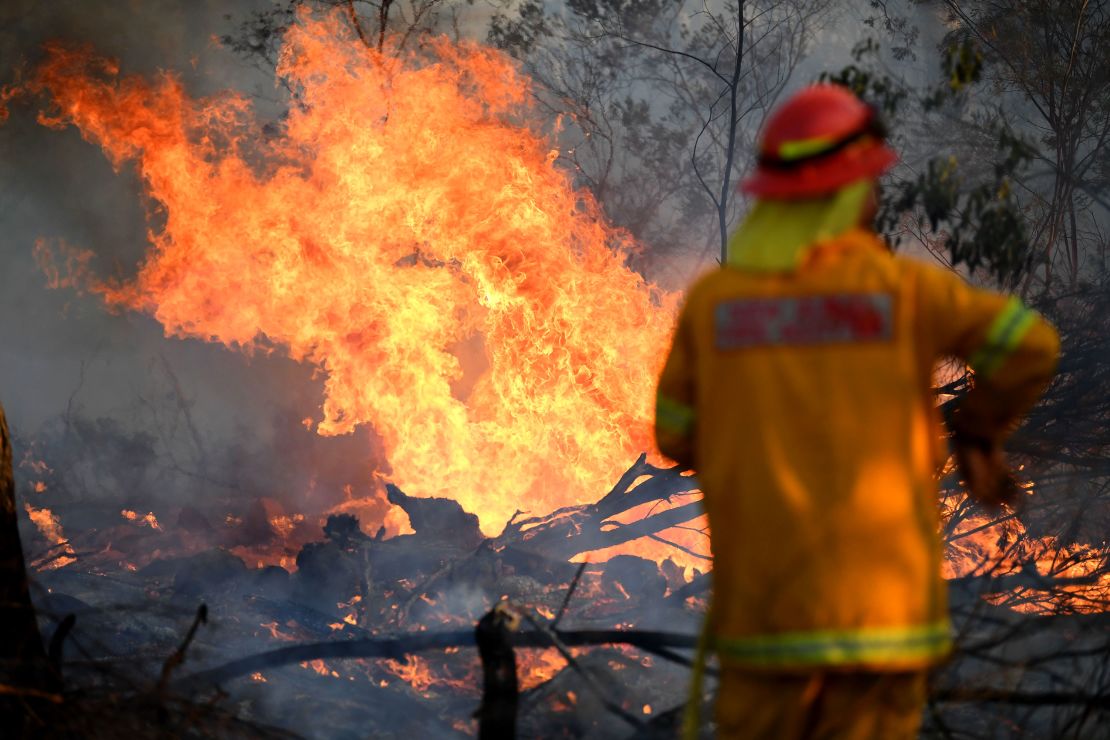 A firefighter works to contain a bushfire near the town of Glen Innes in the state of New South Wales on Sunday.