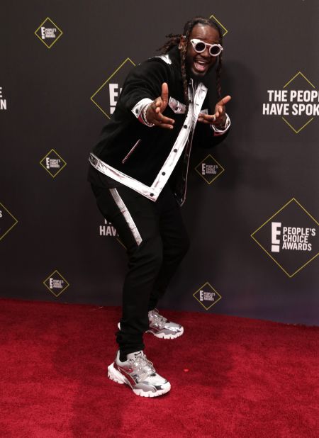 T-Pain arrives sporting thick silver trim and sneakers.