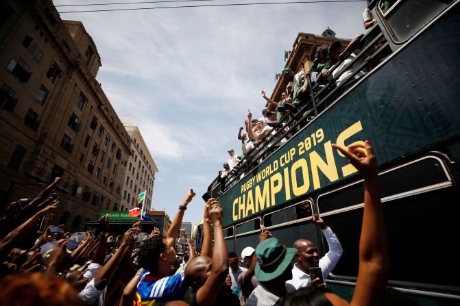 Members of the South African rugby team celebrate alongside fans during the <a href="index.php?page=&url=https%3A%2F%2Fedition.cnn.com%2F2019%2F11%2F07%2Fsport%2Fspringboks-south-africa-bus-parade-spt-intl%2Findex.html%3Fno-st%3D1573458431" target="_blank">World Cup Trophy Tour</a> in Pretoria, South Africa, on November 7. The team's 32-12 win over England won them the Rugby World Cup for the third time.