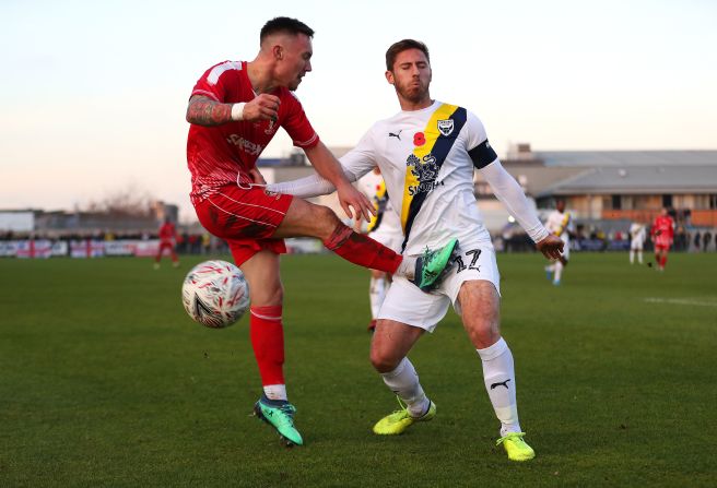 Joe Grant, left, of Hayes and Yeading United and James Henry of Oxford United battle for the ball during the FA Cup First Round match November 10 in Hayes, England.