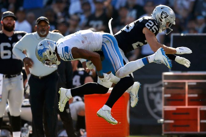 Detroit Lions wide receiver Marvin Jones Jr., left, catches a pass in front of Oakland Raiders free safety Erik Harris during the first half of an NFL football game in Oakland, California, November 3.